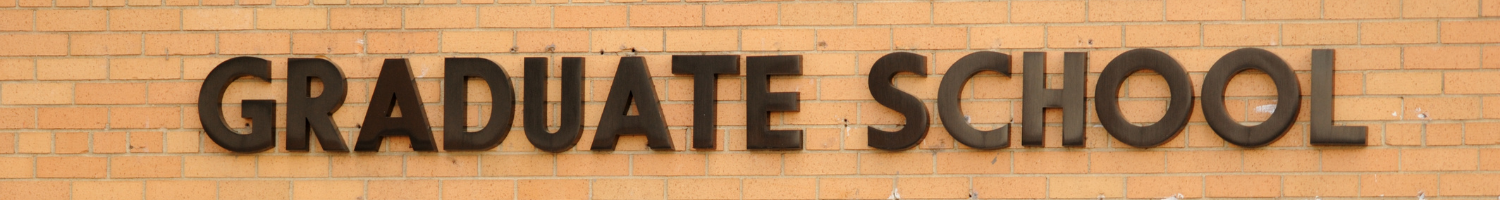 graduate school sign on brick building