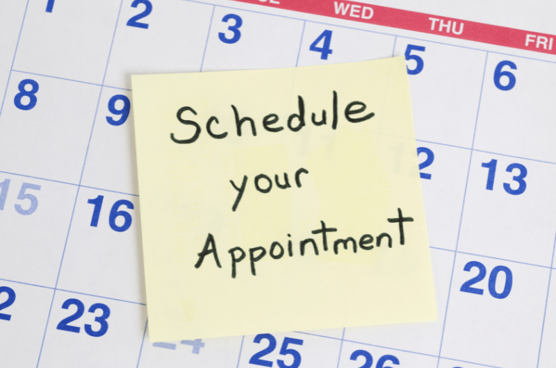 schedule appointment on sticky note on calendar page
